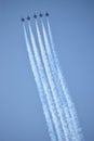 Five blue angel jets flying upward in sync