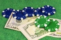 Five blue chips and two green chips lie on two fifty dollar bill Royalty Free Stock Photo