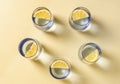 five blue crystal vases with lemon forming a circle, circular overhead photograph