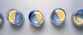 five blue crystal vases in a row with a piece of lemon, panoramic photograph