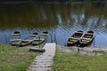 Five boats on the river bank three of them almost sink Royalty Free Stock Photo