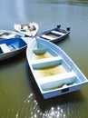The Five small blue boats floating on a river. Royalty Free Stock Photo