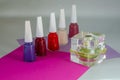 Five bottles of nail polish and one bottle of perfume. Royalty Free Stock Photo