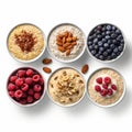 Five bowls of oatmeal with berries and nuts