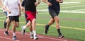 Five boys running fast in a group on a track Royalty Free Stock Photo