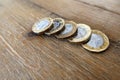 Five British UK pound coins on a wooden table Royalty Free Stock Photo