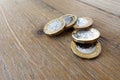 Five British UK pound coins on a wooden table Royalty Free Stock Photo