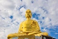 The golden buddha statue on blue sky
