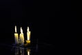 Five burning candles and the Star of David against a black background. Royalty Free Stock Photo