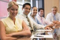 Five businesspeople at boardroom table smiling Royalty Free Stock Photo