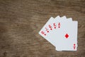 Five card of red diamond royal straight flush on wood background