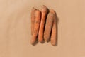 Five Carrots on a Tan Background