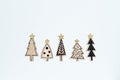 Five carved from wood and painted Christmas trees