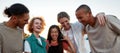 Five casually dressed friends of different nationalities having a good time together outside laughing and smiling Royalty Free Stock Photo