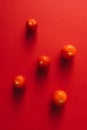 Five cherry tomatoes on a red background. Royalty Free Stock Photo