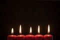 Five Christmas candles in dark background Royalty Free Stock Photo