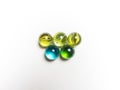 Five colored glass balls with caustics on a white background Royalty Free Stock Photo