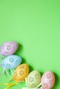 Five colored lace Easter eggs on green background in natural light Royalty Free Stock Photo