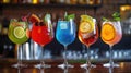 Five colorful gin tonic cocktails in wine glasses adorn the bar counter of a vibrant pub or restaurant. Ai Generated Royalty Free Stock Photo