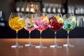 Five colorful gin tonic cocktails in wine glasses on bar counter in pup or restaurant Royalty Free Stock Photo