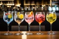 Five colorful gin tonic cocktails in wine glasses on bar Royalty Free Stock Photo