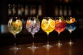 Five colorful gin tonic cocktails in wine glasses on bar counter in pup or restaurant Royalty Free Stock Photo