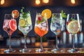 Five colorful gin tonic cocktails in wine glasses on bar counter in pup or restaurant. Royalty Free Stock Photo