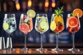 Five colorful gin tonic cocktails in wine glasses on bar counter in pup or restaurant. Royalty Free Stock Photo