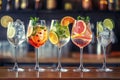 Five colorful gin tonic cocktails in wine glasses on bar counter in pup or restaurant. Royalty Free Stock Photo