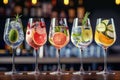 Five colorful gin tonic cocktails in wine glasses on bar counter in pup or restaurant. Royalty Free Stock Photo