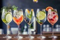 Five colorful gin tonic cocktails in wine glasses on bar counter in pup or restaurant. Royalty Free Stock Photo