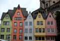 Five colorful homes and a large tower in the center of Cologne in Germany
