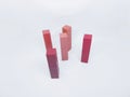 Five Colorful Matte Lipstick Tubes Standing Upright on a Clean White Background Royalty Free Stock Photo