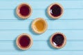 Five colourful jam tarts on a blue background Royalty Free Stock Photo