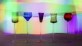 Five Colourful Liqueur Glasses with Bright Lights in the Background.