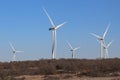 Five contemporary wind turbines in a winter lanscape