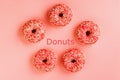 Five coral donuts. Donuts with icing on pink background