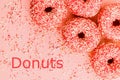 Five coral donuts lying in a corner