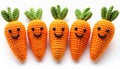 Five Crocheted Orange Carrots with Smiling Faces on White Surface Close Up Royalty Free Stock Photo