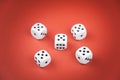 Five dice lie on a red background