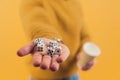 Five dice lying on a hand of a caucasian person. Studio shot over yellow background. Royalty Free Stock Photo