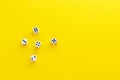 Five dice showing different sides on yellow background. Playing cube with numbers. Items for board games. Flat lay top view with