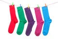 Five different color socks hang on rope