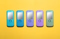 Five different colors of mobile phones in a line