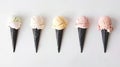 Five different flavors of ice cream served on elegant dark cones, arranged in a neat row against a white background Royalty Free Stock Photo