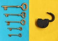 Five different golden keys on blue felt and open padlock on yell Royalty Free Stock Photo