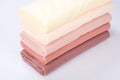 Five rolls of fabric lie on a white background. gradient beige