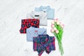 Five different shirts and a bouquet of tulips. Fashionable concept. Assortment