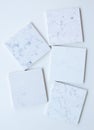 Five different stone samples mainly white based with marble like grains and veins Royalty Free Stock Photo