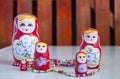 Five dolls and colored beads on the table Royalty Free Stock Photo